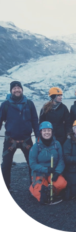 group posing for picture on iceberg