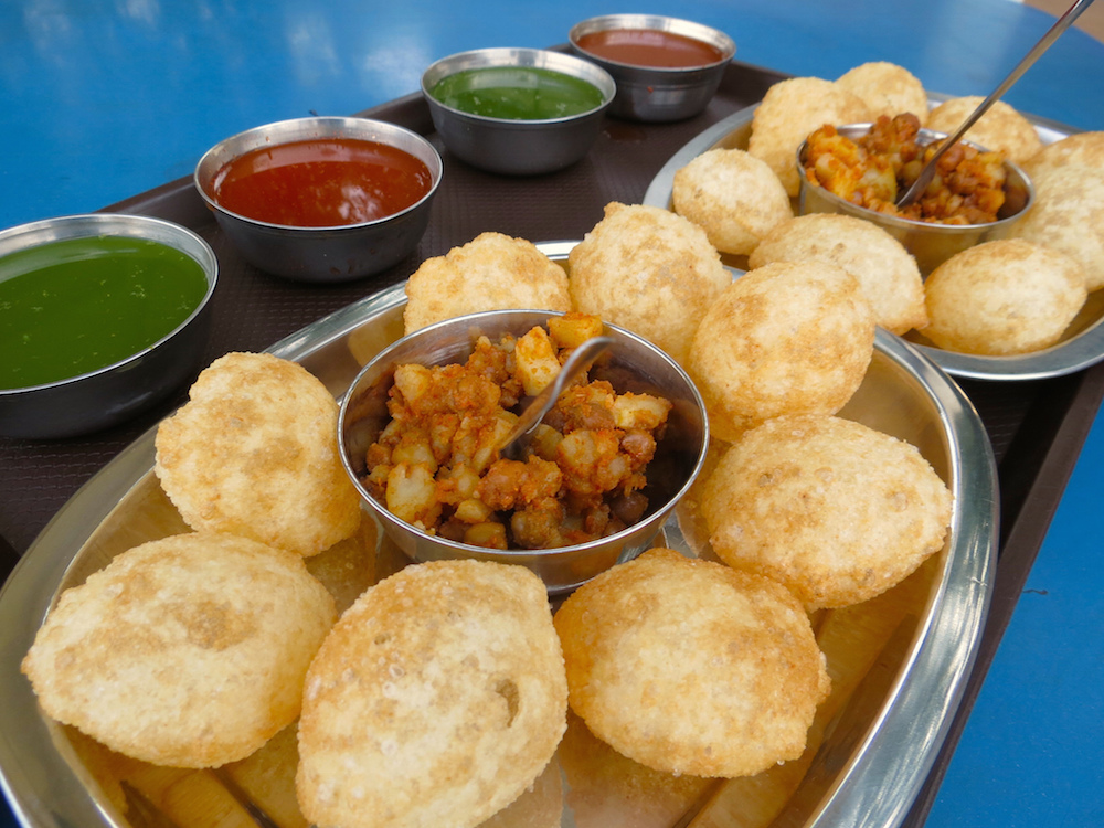 Try out their Pani Puri (crispy hollow shells with chickpeas, potatoes and tamarind chutney served with tangy spicy water) © Apoorva Jinka / Flickr