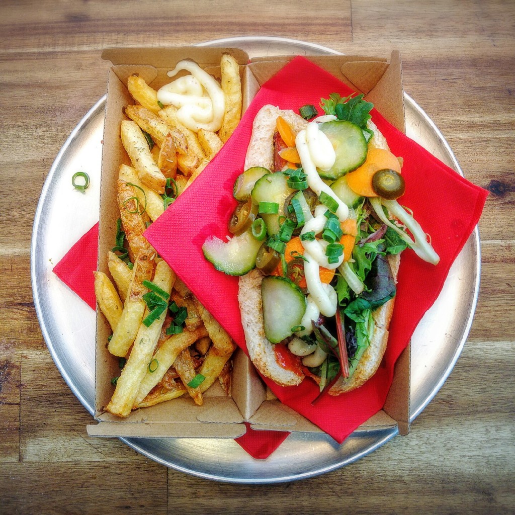 Banh Mi DOG. Wholemeal bread, homemade garlic mayonnaise, beef sausage, 24h marinated carrot, cucumber and jalapeños, coriander and cheddar cheese, served with a side of homemade chips | Courtesy of Wassup Dog
