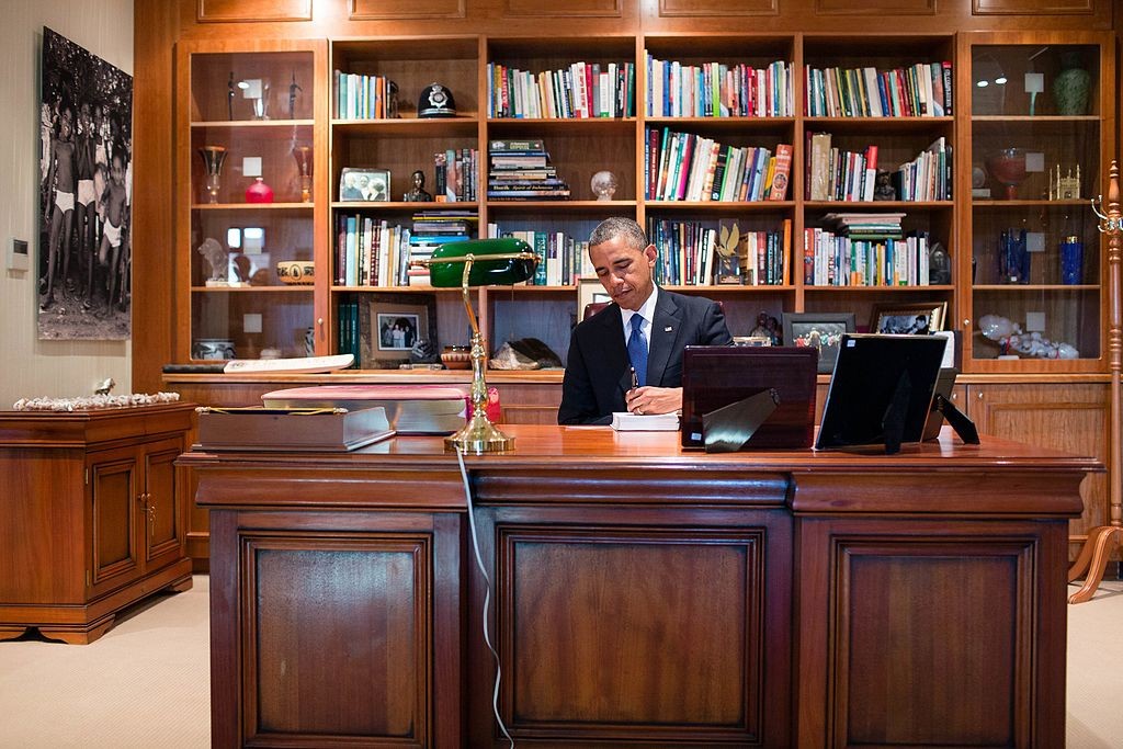 President Barack Obama signs a copy of former South African President Nelson Mandela's book "Conversations with Myself" while visiting Mandela's office at the Nelson Mandela Centre of Memory in Johannesburg, South Africa, June 29, 2013 © The White House/WikiCommons