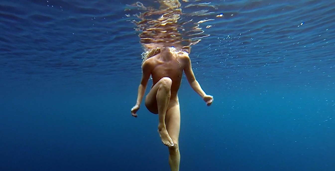 Naked woman swimming