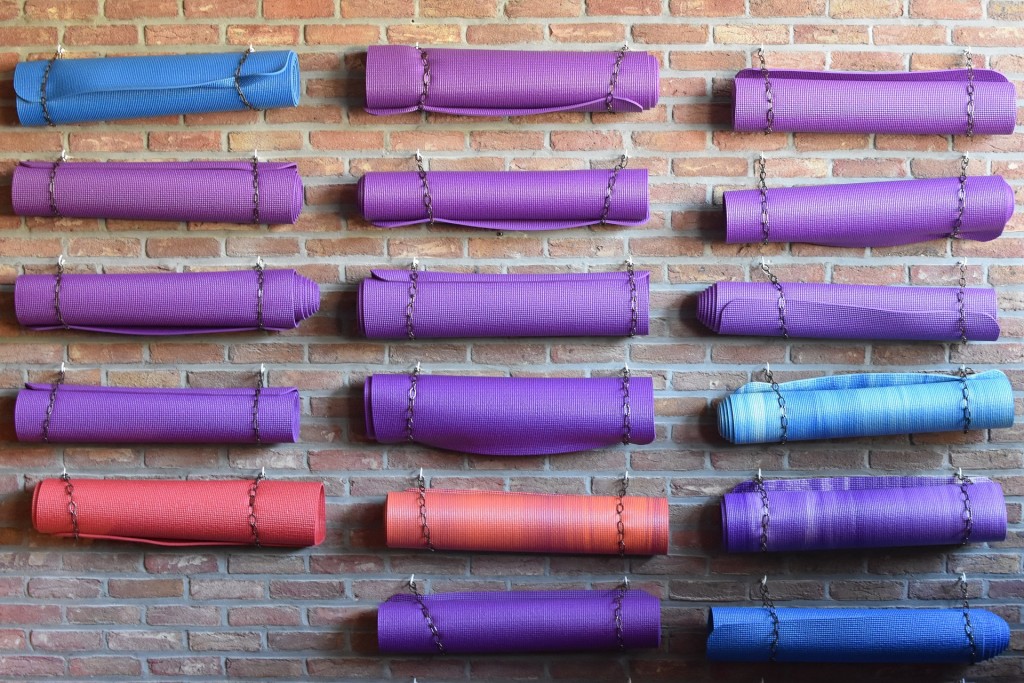 Yoga mats rolled up on a wall