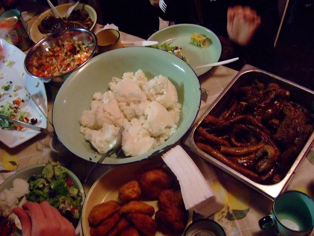 A delicious spread of braai meat, pap and salads at Mzoli's Place © Yosoynuts/Flickr