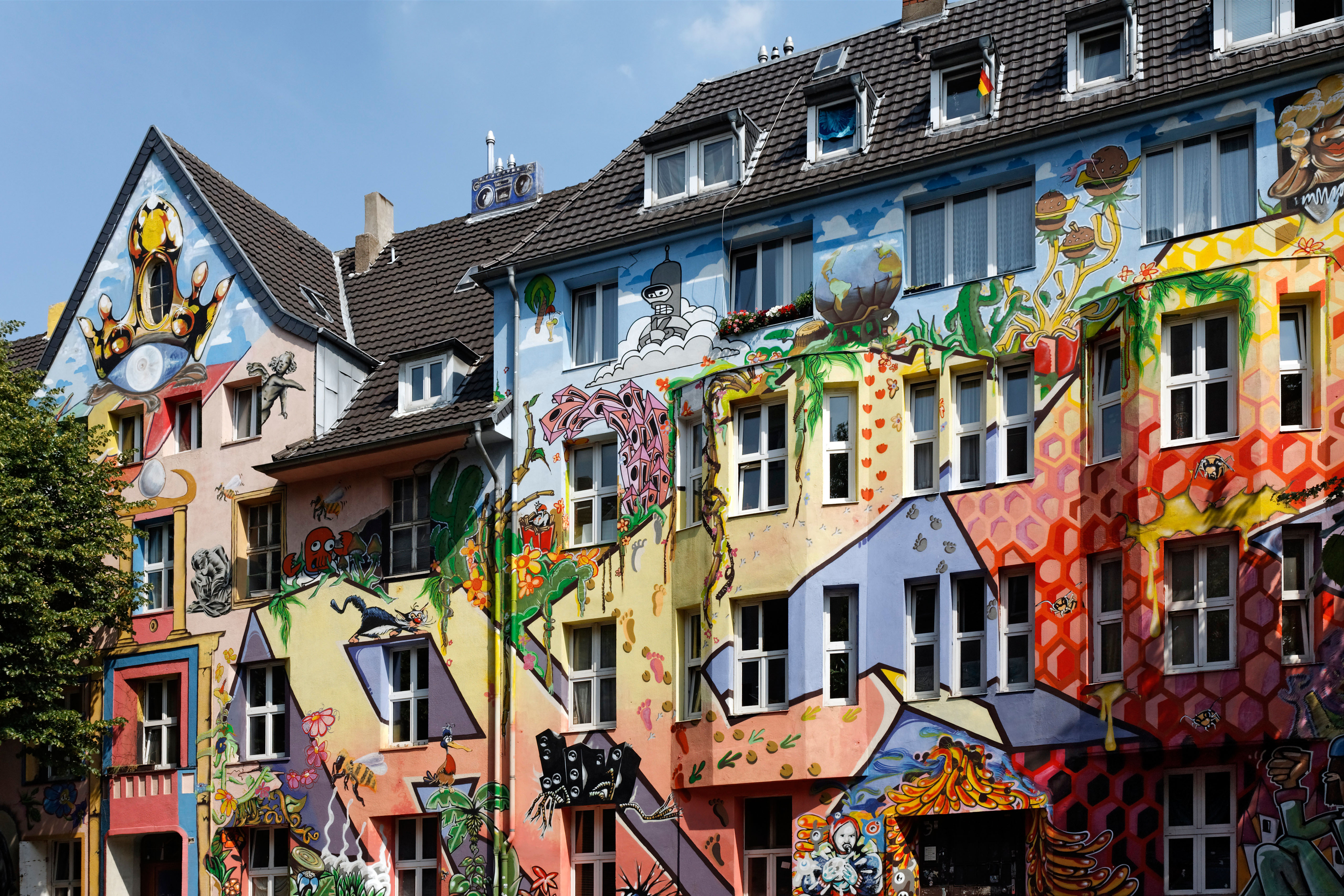Kiefernstrasse street, houses of former squatters, artistically painted facades in street art style, Duesseldorf-Flingern